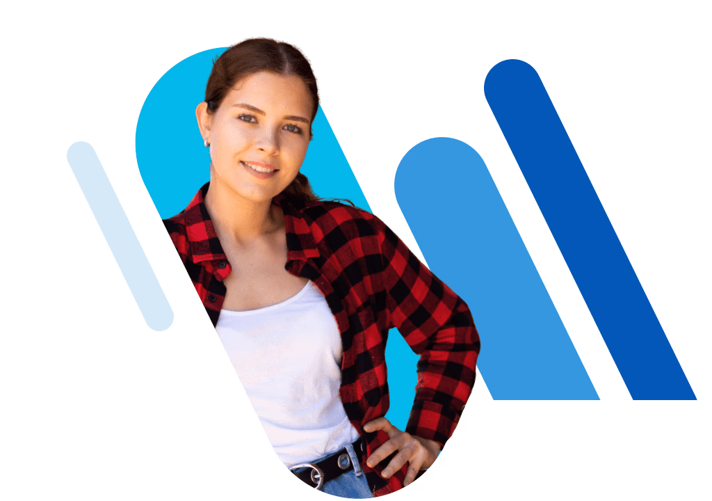 Young woman in a red shirt, one arm on her hip, standing beside blue bars.